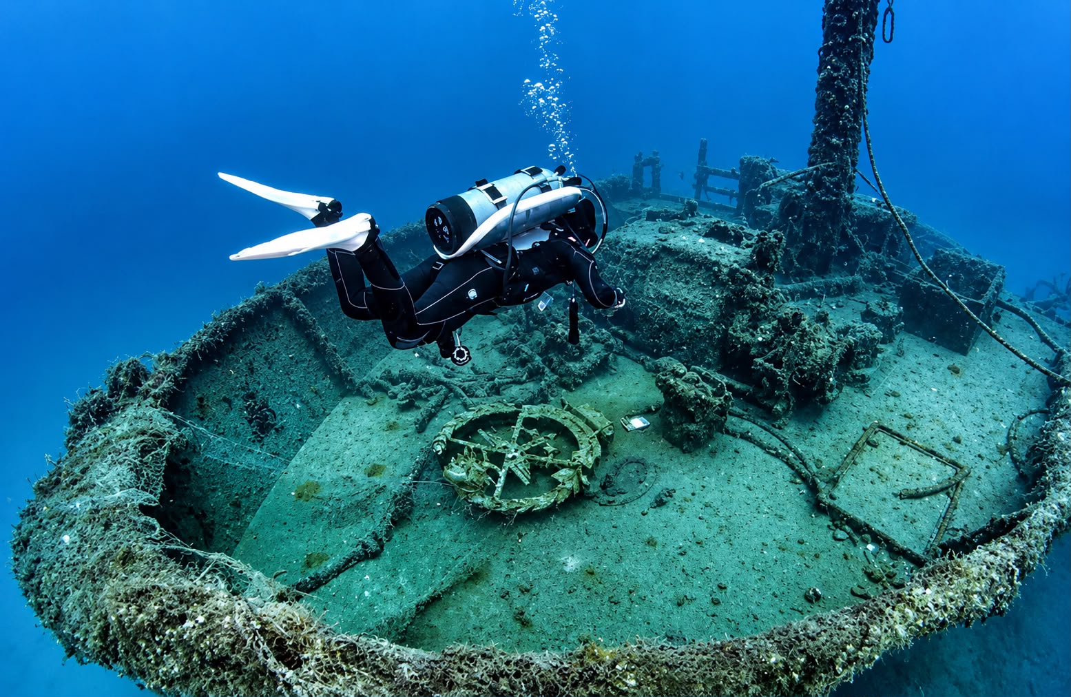 Diver silhouetted above the hull of a shipwreck on the Lebanese Mediterranean seabed